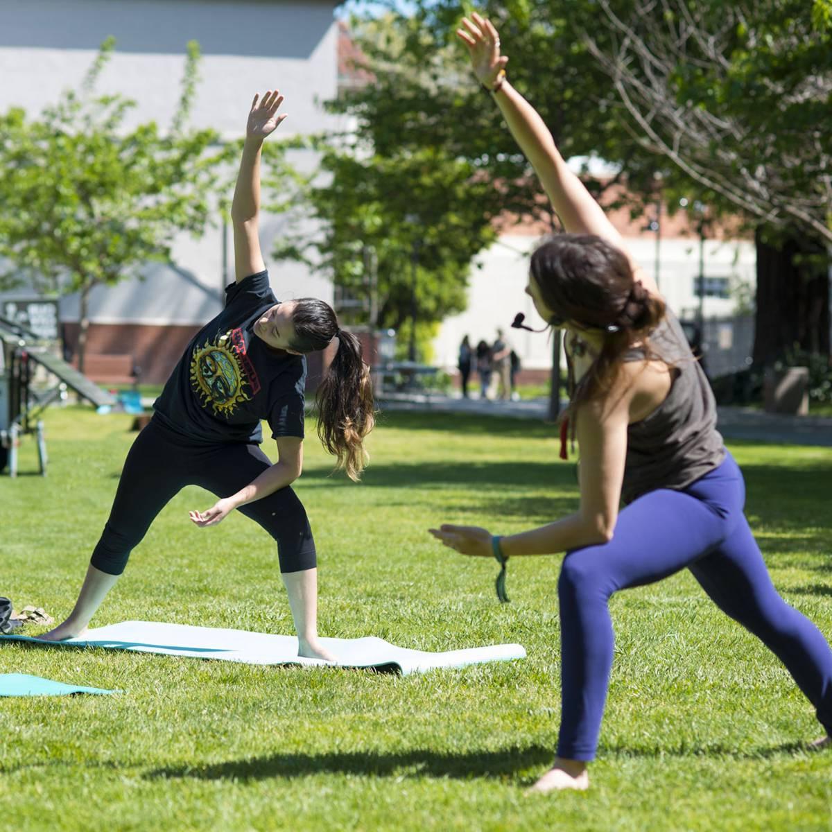 Two people doing yoga