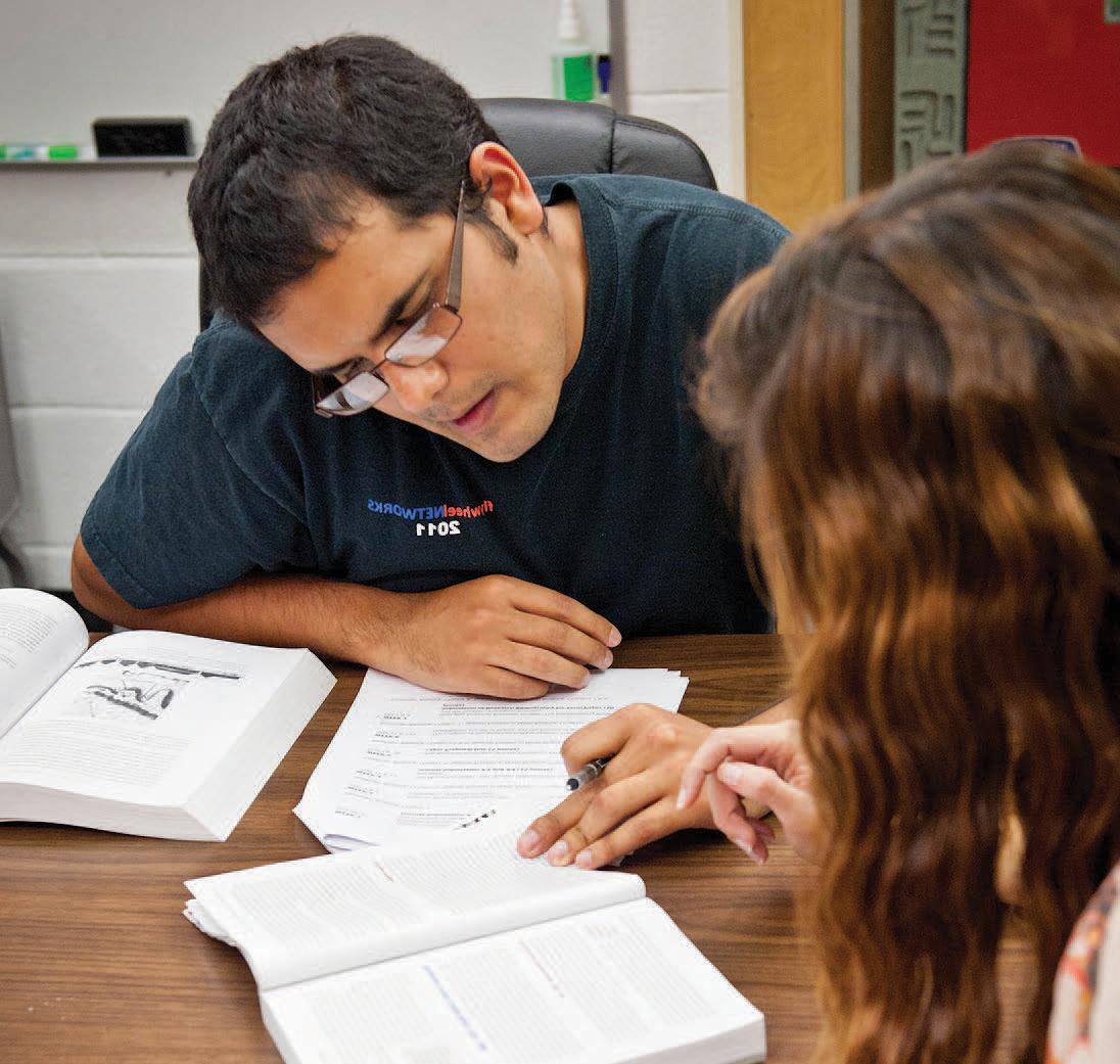 Students study social sciences at a table.