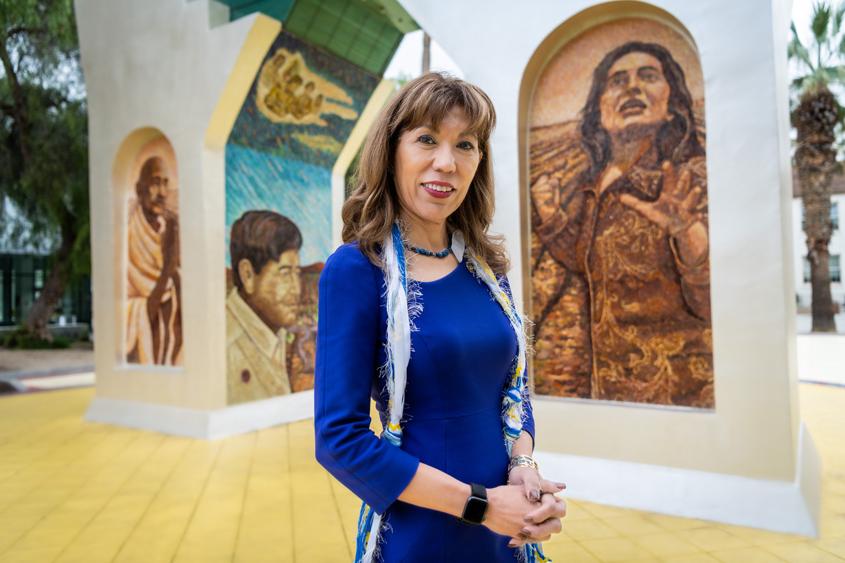 Dr. Cynthia Teniente-Matson posing in front of the Cesar Chavez monument.